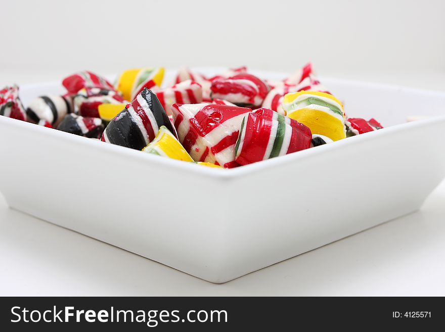 A bowl full of hard candy, very colorful and saturated colors. A bowl full of hard candy, very colorful and saturated colors