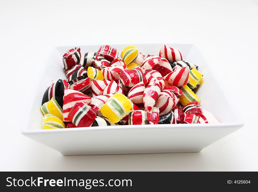 A bowl of hard peppermint candies. A bowl of hard peppermint candies