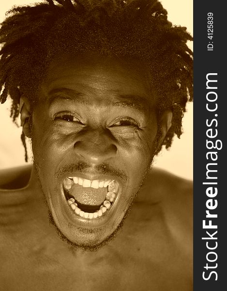 Portrait of an african young man expressing anger in sepia. Portrait of an african young man expressing anger in sepia.