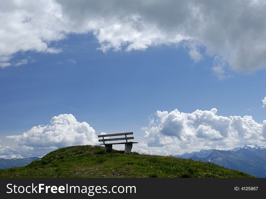 Empty bench on alpine mountain