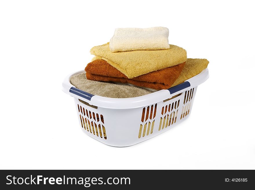 White Basket of clean colorful towels. White Basket of clean colorful towels