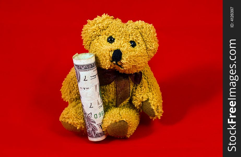 Teddy bear holding one dollar bill. Teddy bear holding one dollar bill