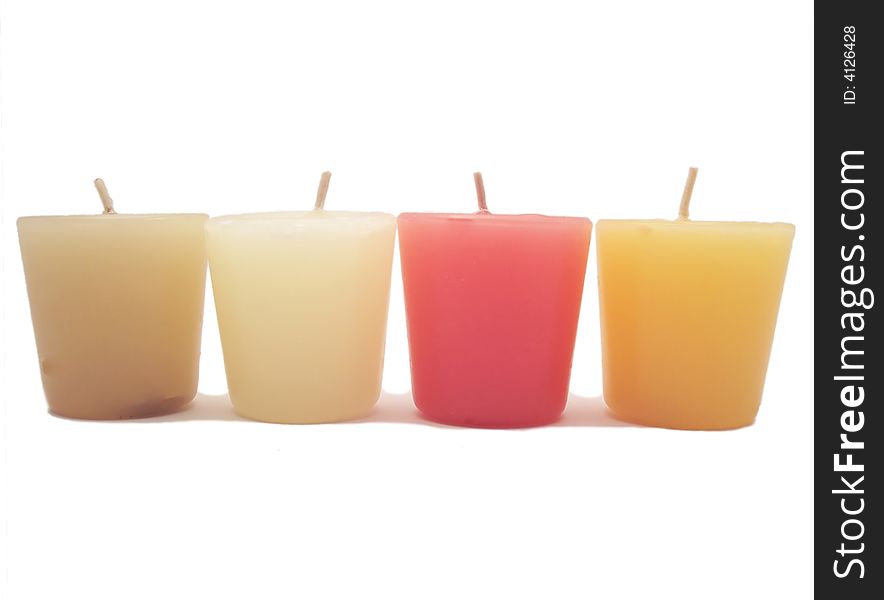 Four different colored candles over a white background. Four different colored candles over a white background