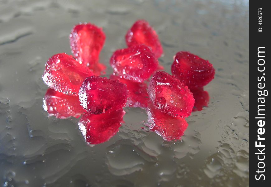 Reflection in a mirror of grains of a pomegranate similar to rubies. Reflection in a mirror of grains of a pomegranate similar to rubies