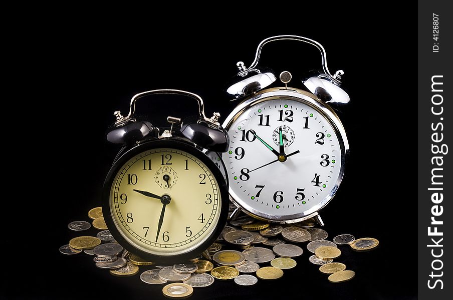 Alarm clocks and euro coins, close up. Alarm clocks and euro coins, close up