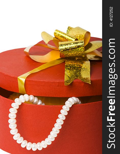 Closeup isolated heart shape box with pearl necklace and gold ribbon. Closeup isolated heart shape box with pearl necklace and gold ribbon