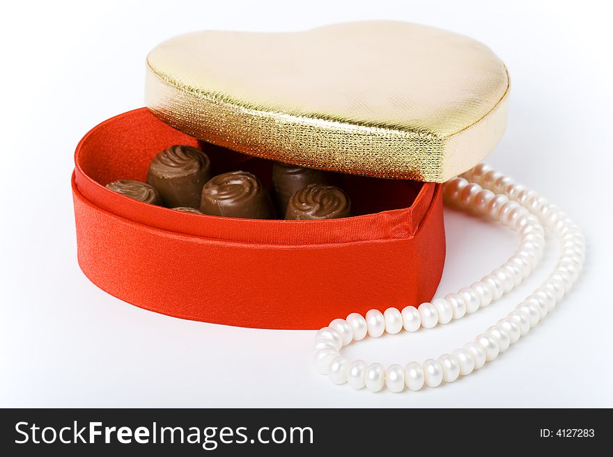 Red box with chocolate and pearl necklace