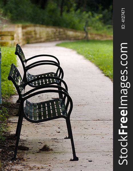 A pair of empty benches in the park