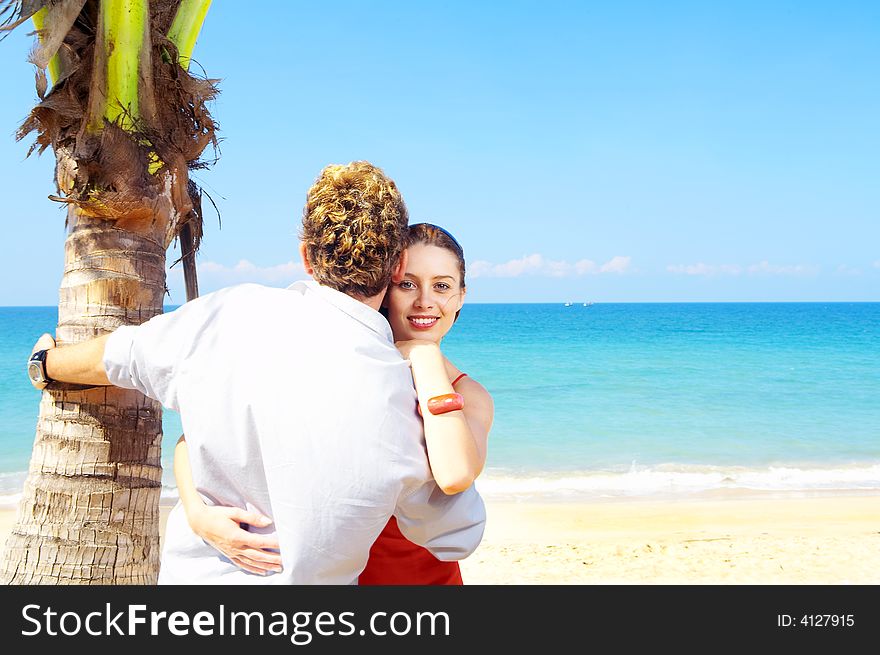 A portrait of attractive couple having date on the beach. A portrait of attractive couple having date on the beach