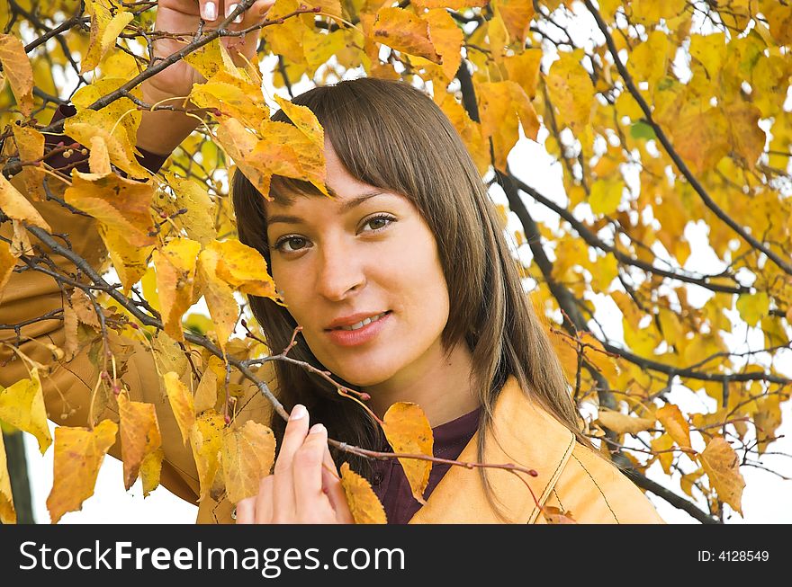 The beautiful girl in yellow  leaves
