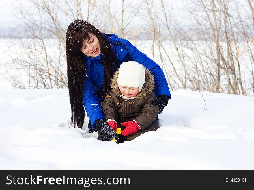 Mother and child playing with snow