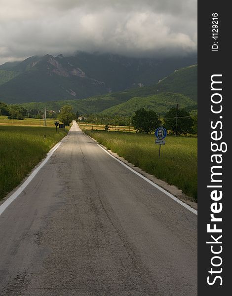 A road leads into the mountains of the central Appenines in Le Marche, central Italy. A road leads into the mountains of the central Appenines in Le Marche, central Italy