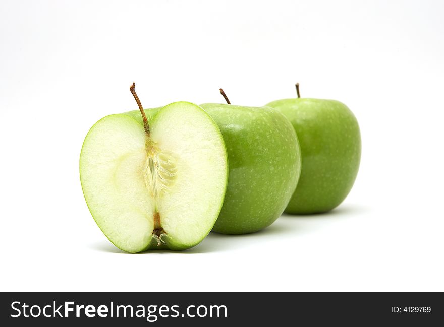 Fresh green apples with half isolated on white