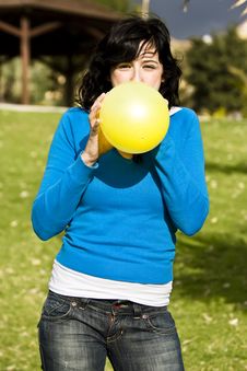 Teen Inflating Yellow Balloon Royalty Free Stock Photography Teen Inflating Yellow Balloon Royalty Free Stock Photography