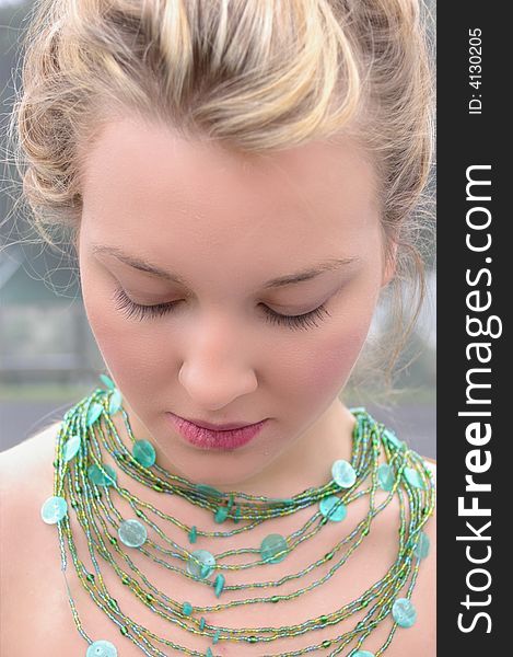 Beautiful Girl wearing a green necklace. Beautiful Girl wearing a green necklace