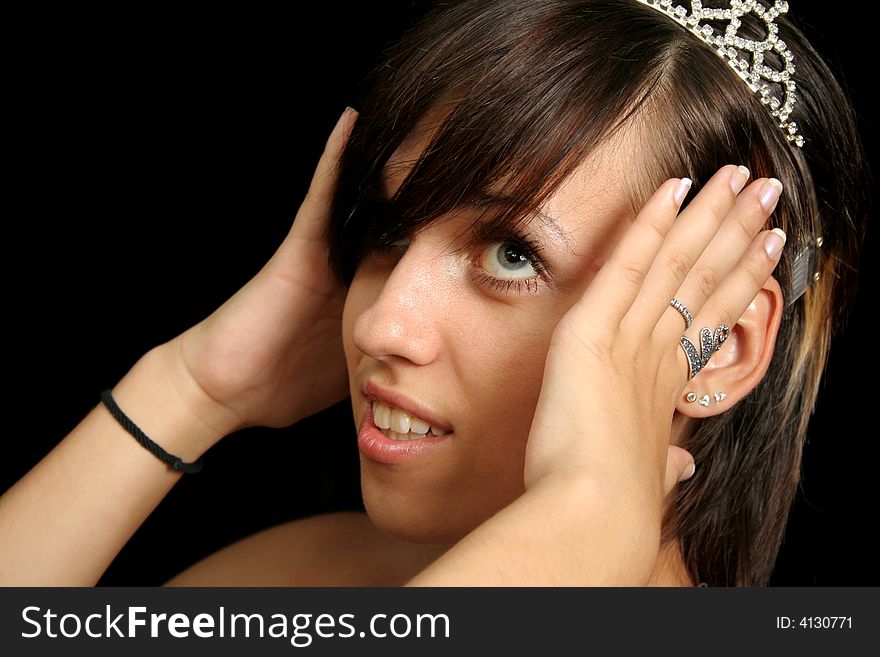 Girl with a diadem, isolated on black