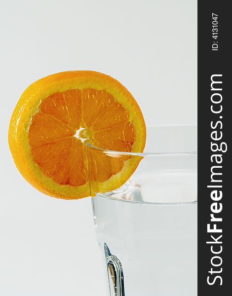 Orange slice on glass of water isolated. Orange slice on glass of water isolated