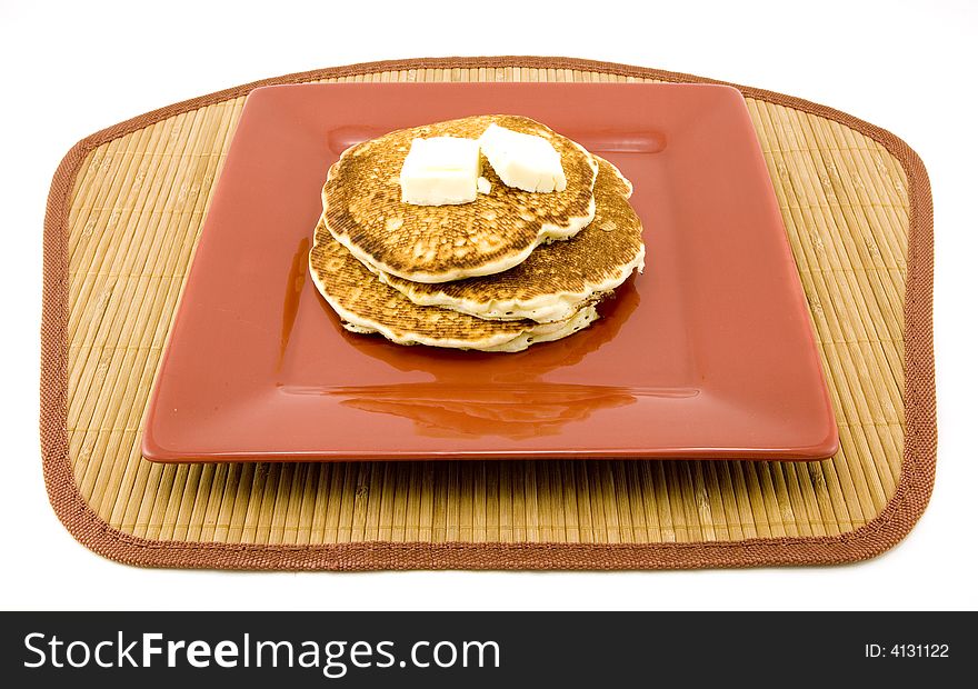 Plate of pancakes and butter isolated on white background. Plate of pancakes and butter isolated on white background.
