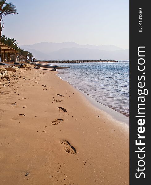 Footprints on the sea sand