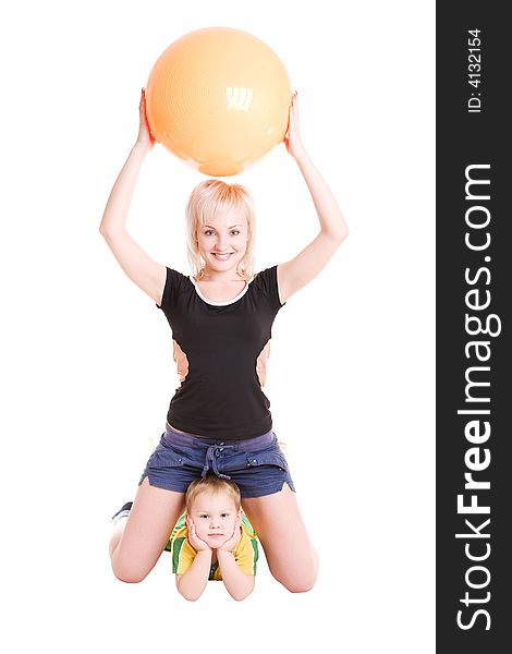 Smiling happy young mother and her son with a fitness ball on the floor. Smiling happy young mother and her son with a fitness ball on the floor