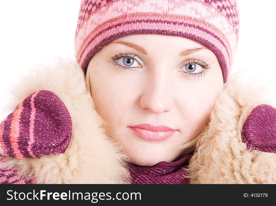 A serious beautiful young woman with a fur collar put up