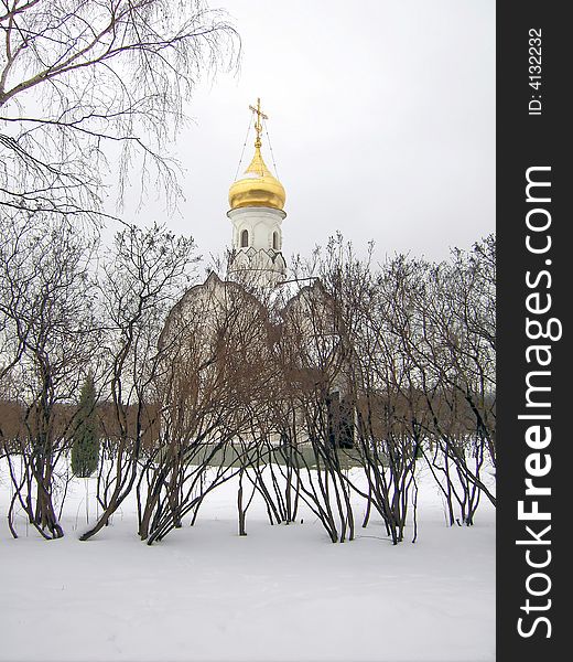 Orthodox chapel in the winter on a background of trees and snows.
