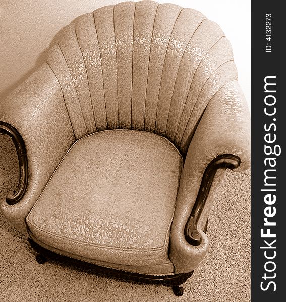 Antique Chair with brown woodend accents and fabric detail