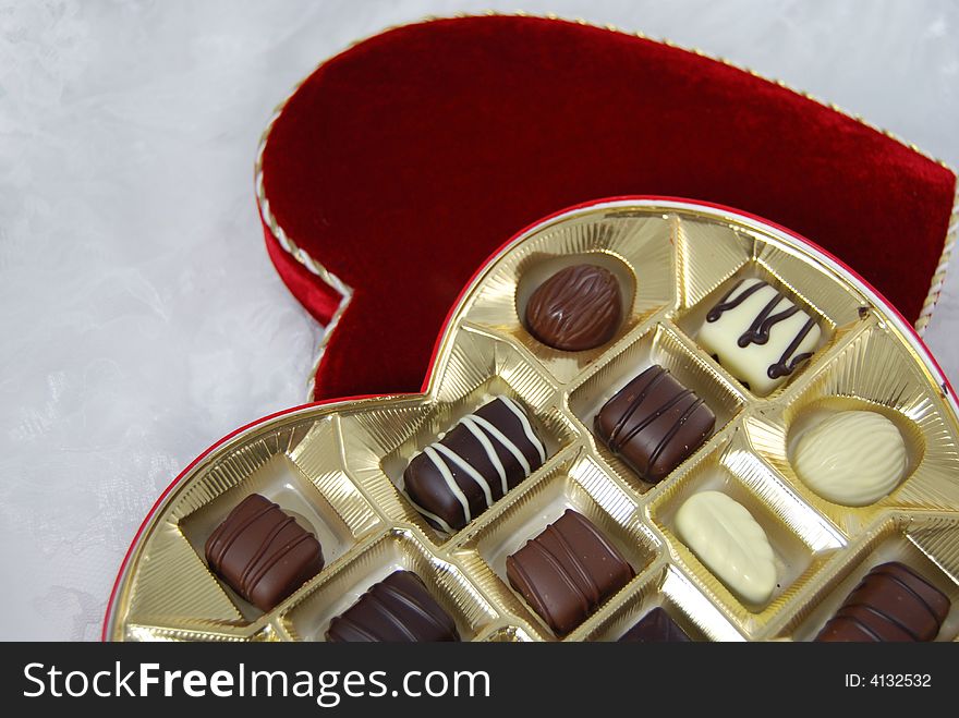 Tasty. fancy chocolates in a heart shaped box. Tasty. fancy chocolates in a heart shaped box.