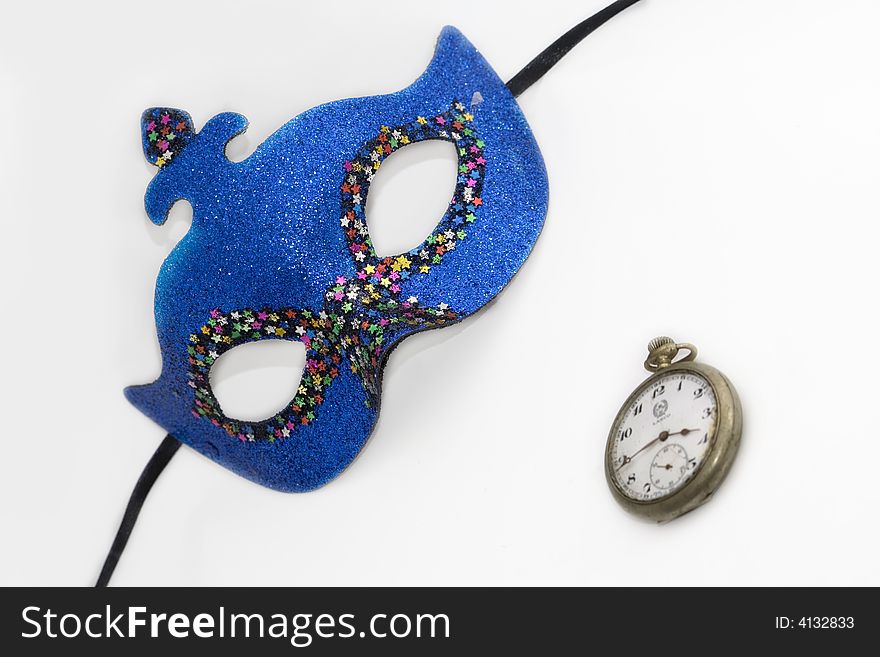 Blue carnival mask on old clock white. Blue carnival mask on old clock white