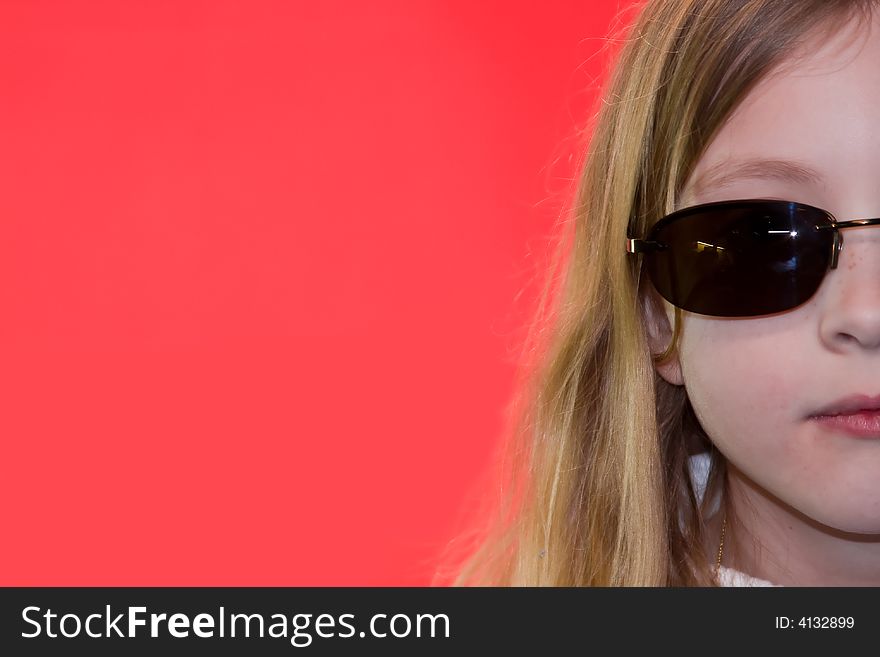 Blonde girl wearing sunglasses on pink background