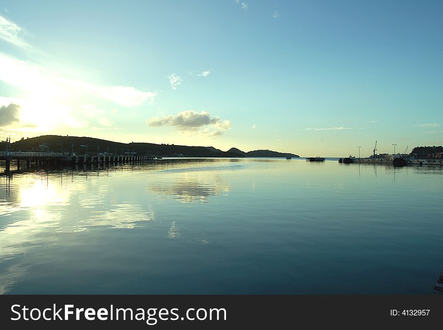 Sunset reflecting in water at empty dockyard. Sunset reflecting in water at empty dockyard