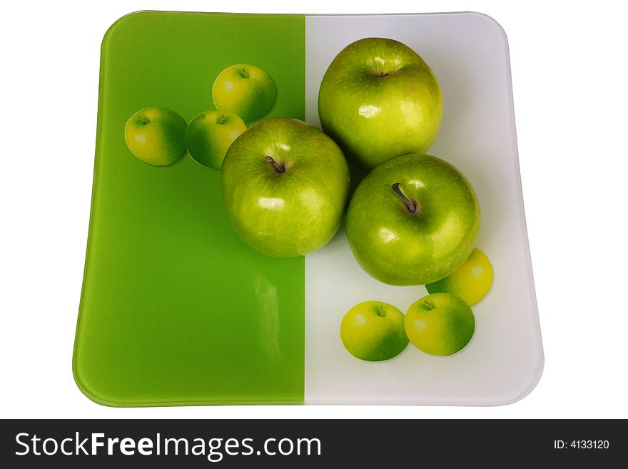 Three fresh apples in a plate on a white background