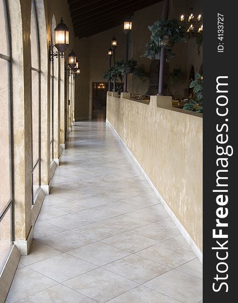 A natural light lit hallway with marble floor. A natural light lit hallway with marble floor