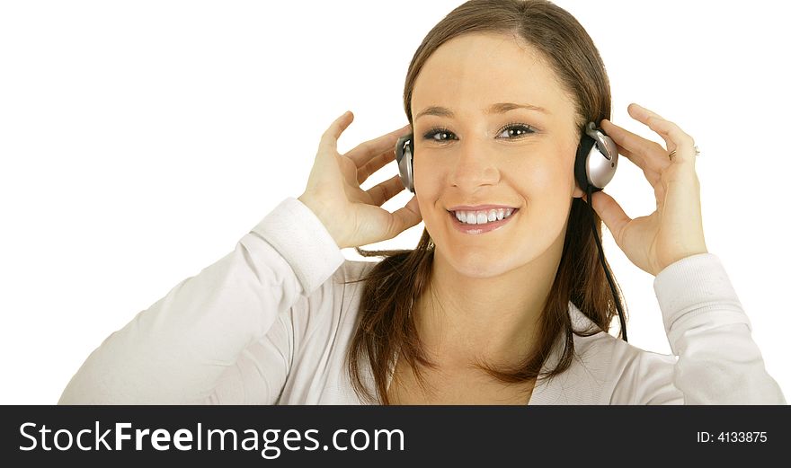 Caucasian girl wearing headset and holding it while smiling and looking at camera. Caucasian girl wearing headset and holding it while smiling and looking at camera