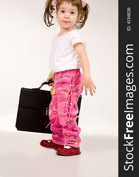 Little girl with suitcase on white