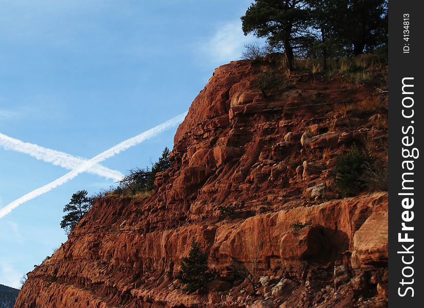 X Marks the Spot ! V2 A picture of two plane trails in the sky next to a beautiful piece of Colorado landscape.