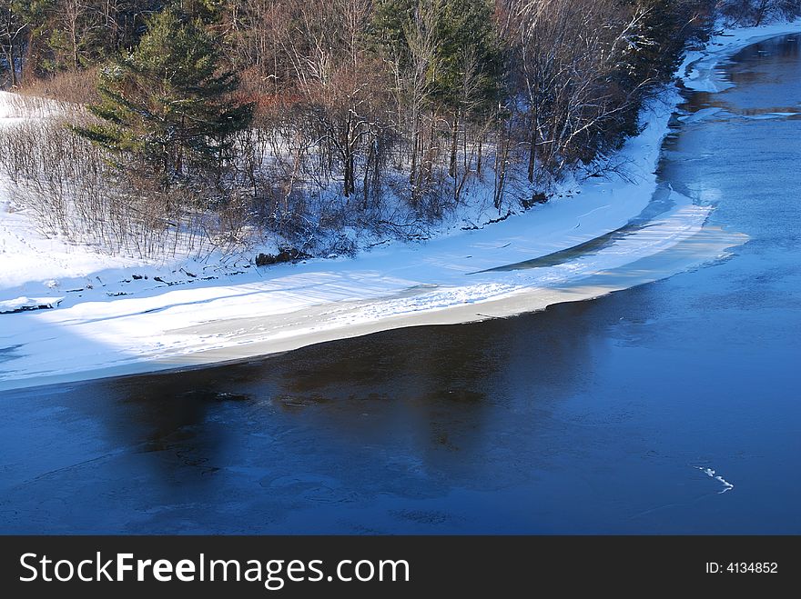 Ice is building up along the shore of the river in the winter. Ice is building up along the shore of the river in the winter.