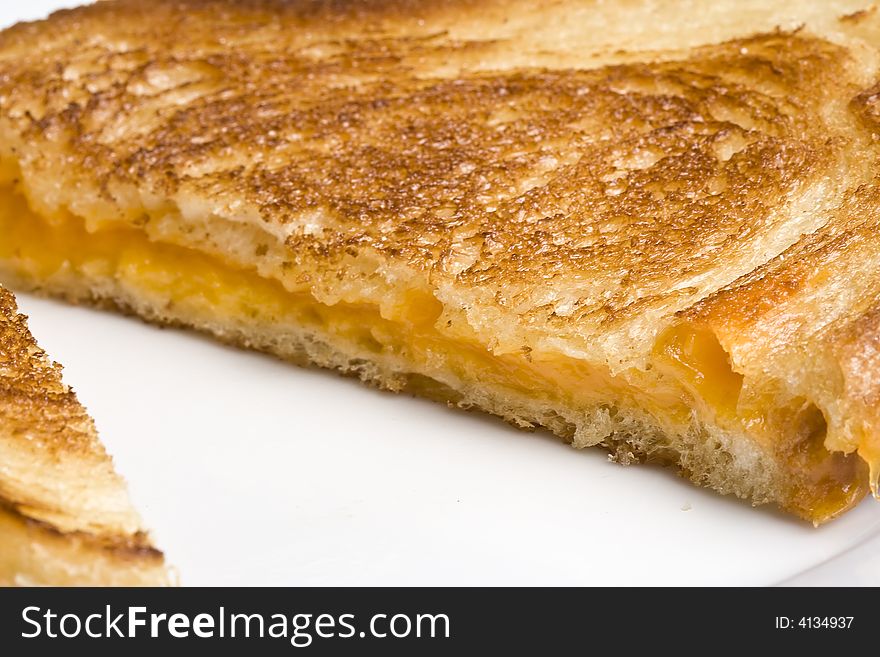 Grilled cheese sandwich on a white plate shot with a macro lens. Grilled cheese sandwich on a white plate shot with a macro lens