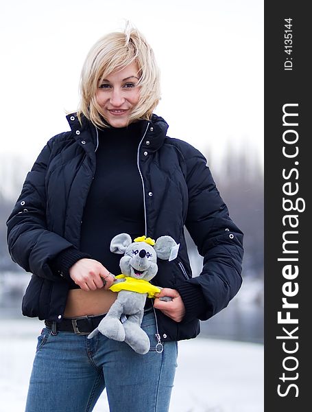Young blonde woman with toy gray rat