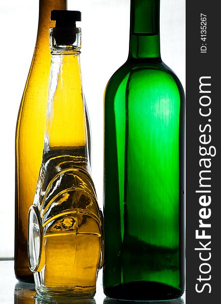 Some vine bottles standing on the glass