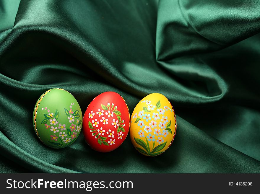 Easter Eggs on Green Satin Fabric