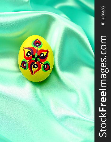 Easter Egg On Turquoise Satin Fabric