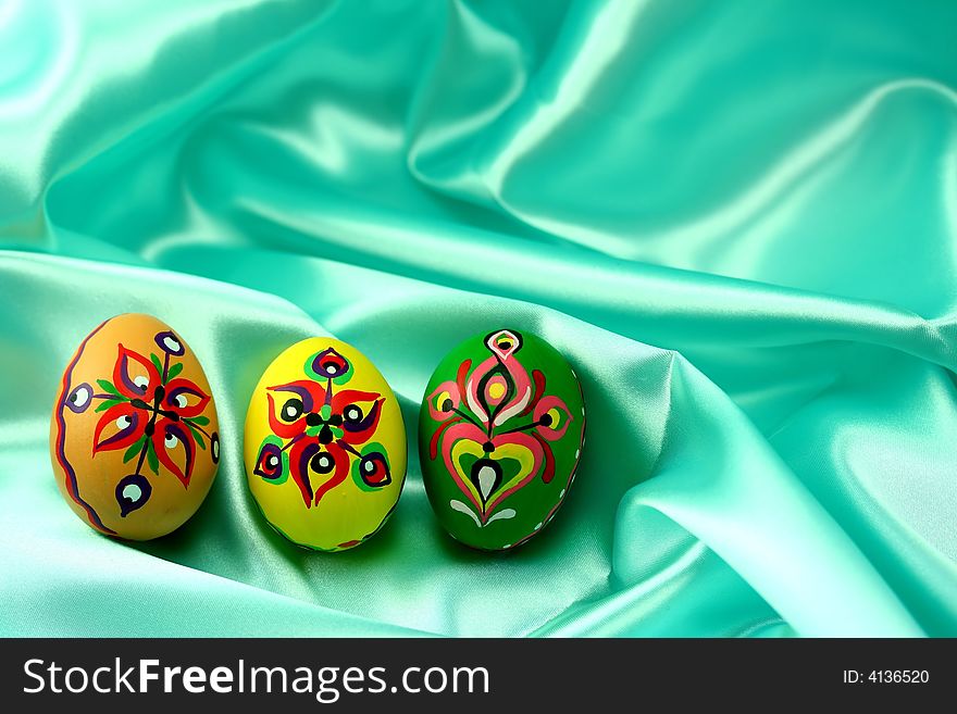 Ornamental Easter Eggs On Turquoise Satin