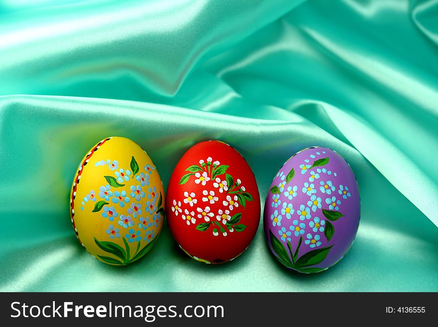 Easter Eggs on Turquoise Satin Fabric