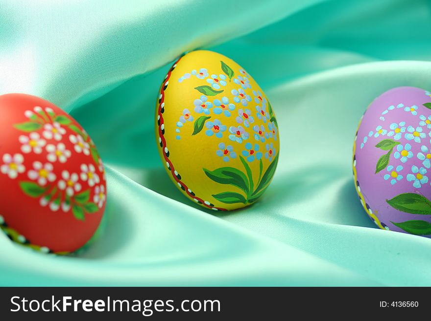 Easter Eggs on Turquoise Satin Fabric