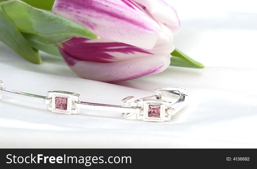 Violet tulip and silver bracelet - still life