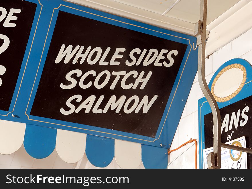 English fishmonger sign advertising Whole Sides Scotch Salmon. English fishmonger sign advertising Whole Sides Scotch Salmon