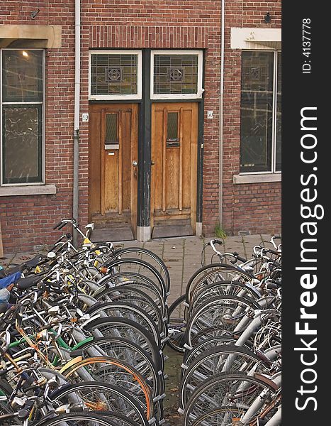 Bicycles parked in front of a residential building. Bicycles parked in front of a residential building