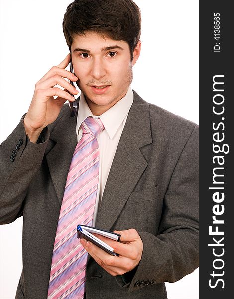 Attractive young businessman with phone and diary