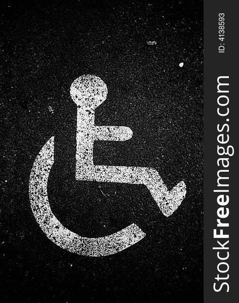 An handicapped sign or symbol on the floor of the street